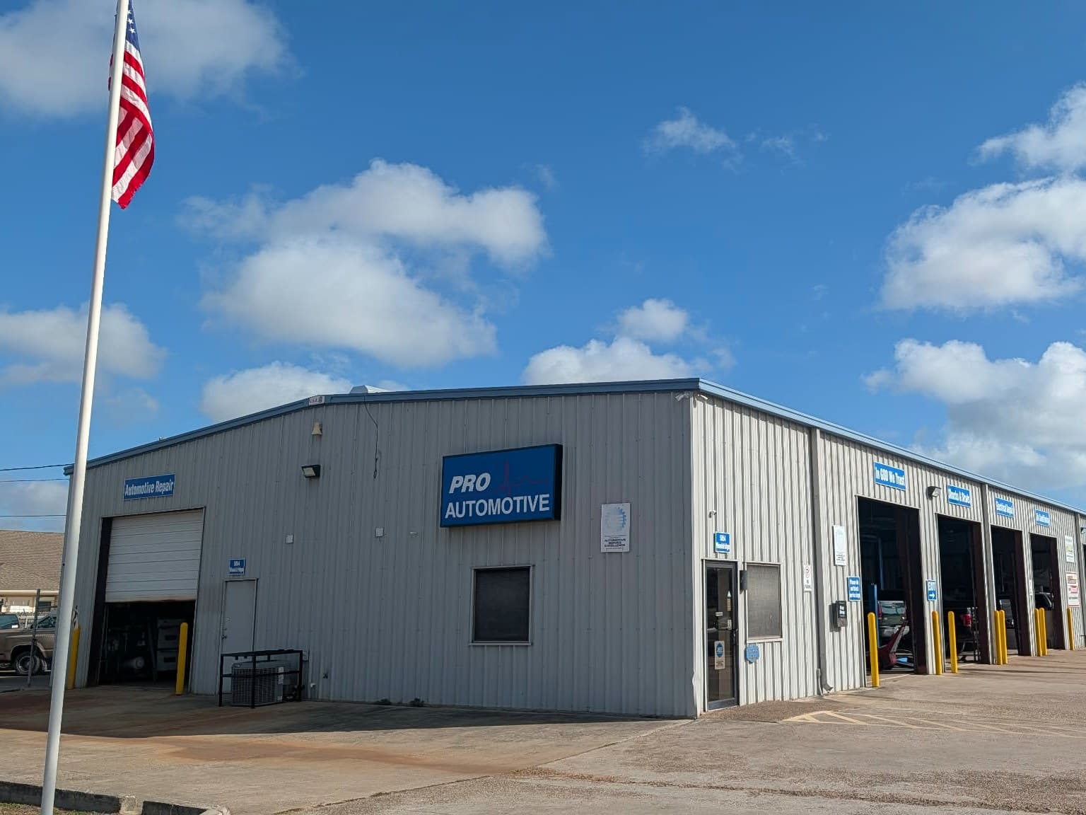 The Pro Automotive Center shop on Wooldridge Rd in Corpus Christi, with its blue Pro Automotive sign and service bays open